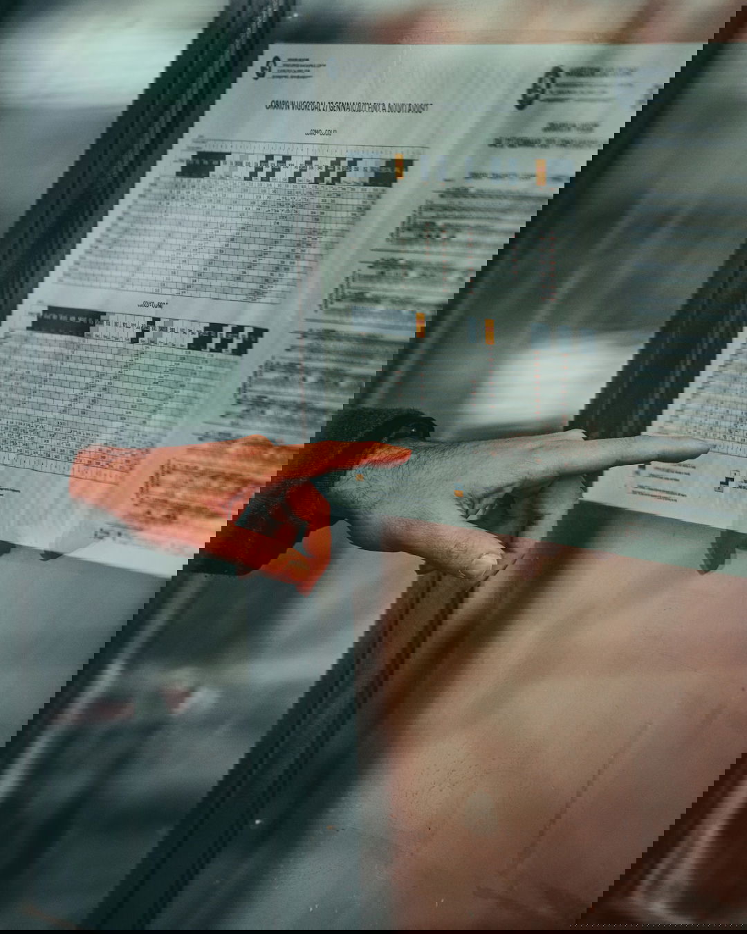 a person pointing at a poster on a wall